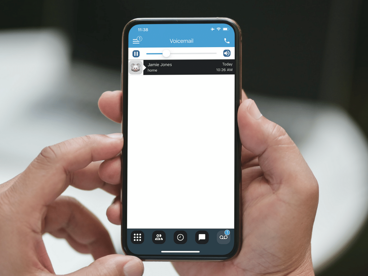 person holding phone with fongo mobile app's voicemail screen open
