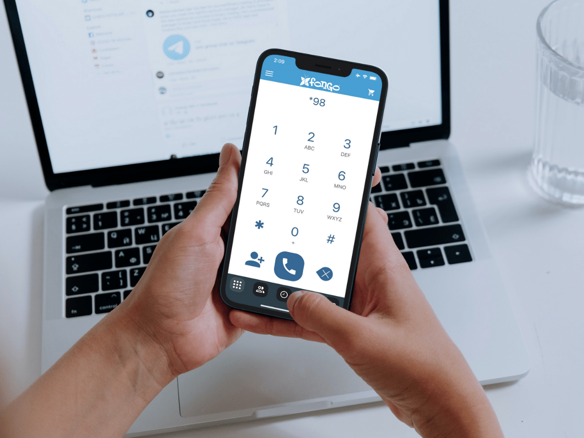 person holding a phone with the fongo mobile app open on the dial pad